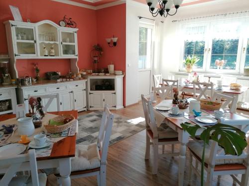 a kitchen with a table and chairs in a room at Pension Weißer Hirsch in Schwarzenberg (Erzgebirge)