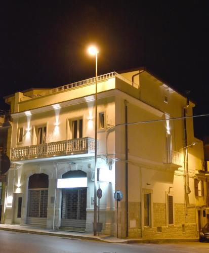a white building with a balcony at night at Finestre sul Borgo in Cassano delle Murge