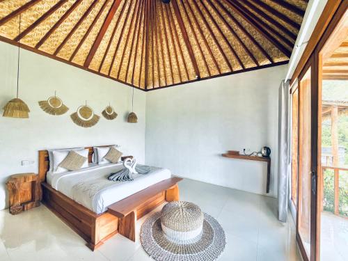a bedroom in a villa with a bed and a table at Hillside bali in Kubupenlokan