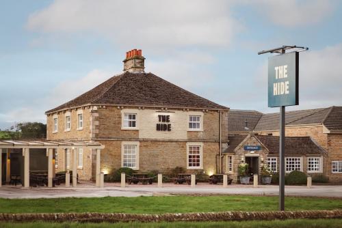 a large brick building with a sign in front of it at The Hide in Chesterfield