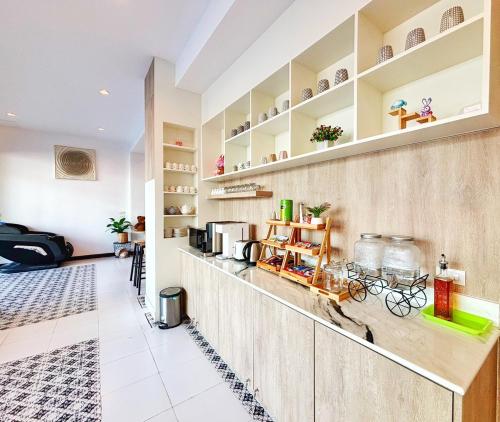 a kitchen with a counter and shelves at The Brown Boutique Patong in Patong Beach