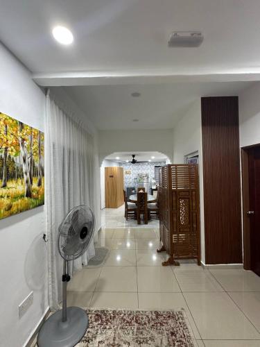 a living room with a fan on the floor at AliyaRoseMuslim Homestay in Ayer Keroh