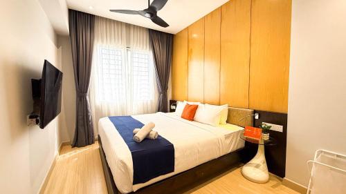 a bedroom with a bed with a stuffed animal on it at Windmill Upon Hills Premium Suites Genting Highland in Genting Highlands