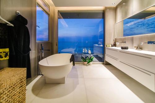 a bathroom with a white toilet and a large window at Hayarkon Apartment By the Sea in Tel Aviv