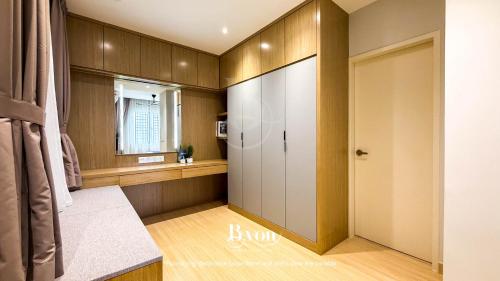 a room with a closet with a mirror and a window at Windmill Upon Hills Premium Suites Genting Highland in Genting Highlands