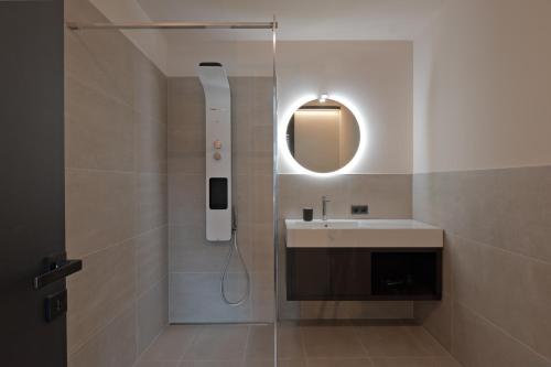 a bathroom with a shower with a sink and a mirror at Z-Apartment Parkgasse in Schladming
