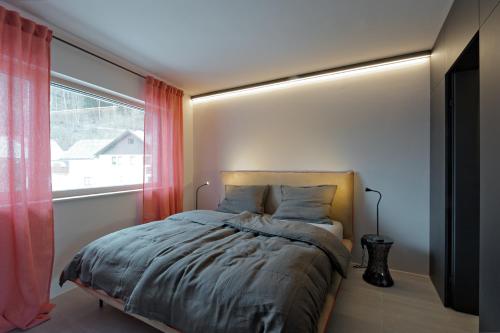 a bedroom with a bed and a window at Z-Apartment Parkgasse in Schladming