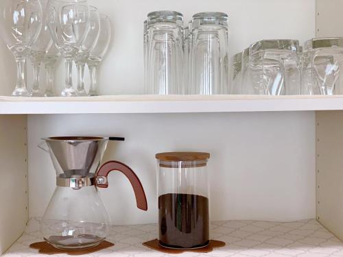 a blender sitting on a shelf with glasses at Vacation stay fujiyoshida in Fujiyoshida
