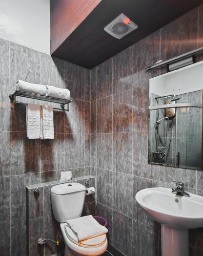 a bathroom with a toilet and a sink at Eastland Hotel in Nairobi