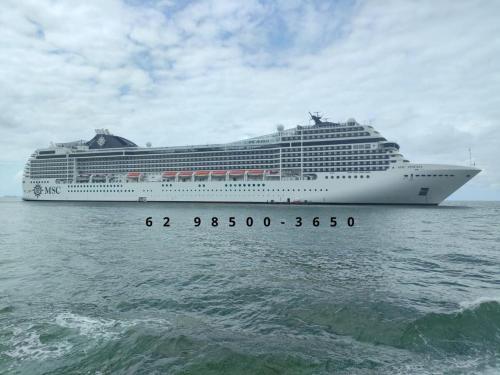 a large cruise ship in the ocean on the water at Avenida Brasil, Balneário Camboriú in Balneário Camboriú