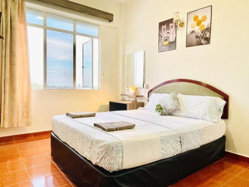 a bedroom with a large bed with a large window at GloryBeachResort2BedroomWifiNetflixFreeparking in Port Dickson