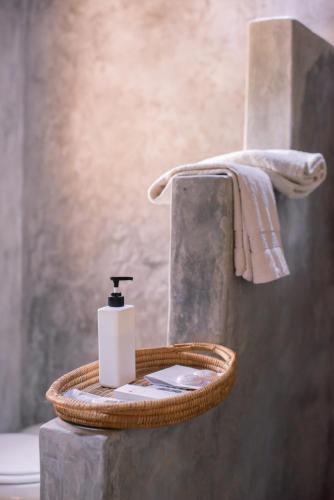 a bathroom with a soap dispenser in a basket at Blue Waters by Serendib in Senga