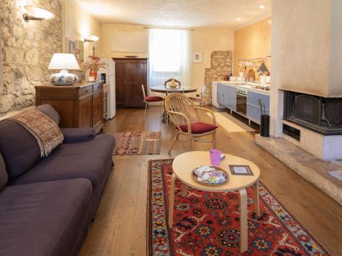 a living room with a couch and a table at From the city to nature Mezzane di sotto VR pet-friendly in Postuman