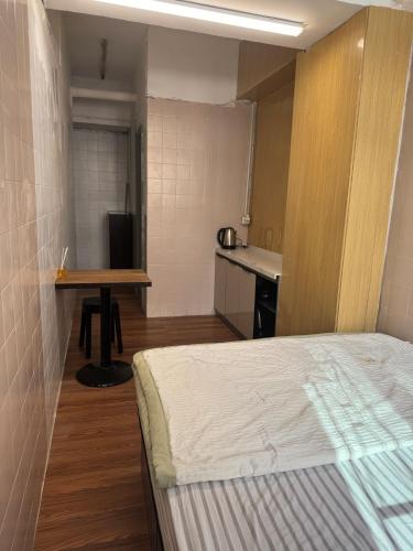una camera con letto e tavolo e una cucina di 旅居1号 a Hong Kong