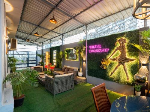 a room with a wall with a woman on it at Hilltop Hideaway Party Friendly 4BHK Pool Villa by Spacez in Mumbai