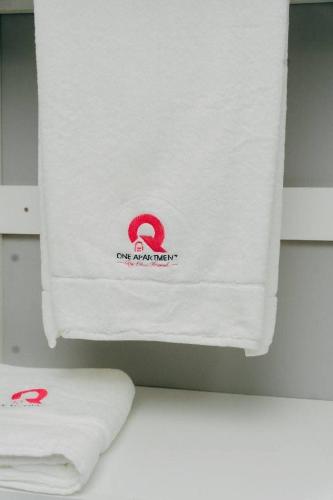 a towel hanging on a wall in a bathroom at One Apartment in Gaborone