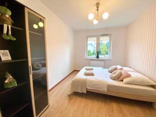 a bedroom with a bed and a large mirror at Apartament na Saperskiej in Płock