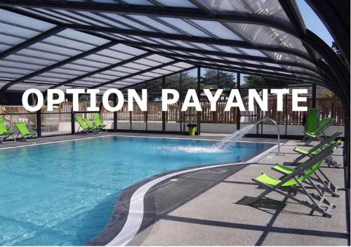 a swimming pool with green chairs and a convention pavilion at Camping Quiberon - Mobilhomes Bord de Mer, Conguel in Quiberon