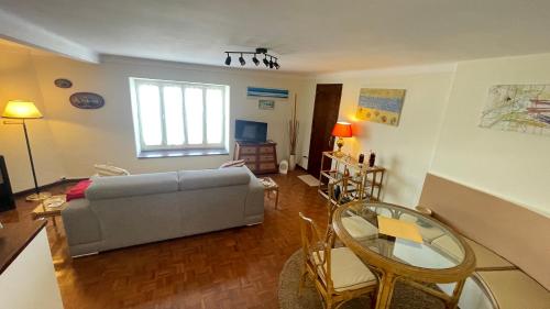 a living room with a couch and a glass table at CASA da LINHA in Deveza