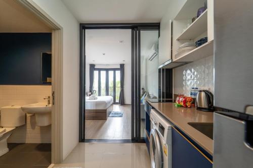 a kitchen with a sink and a bathroom at 1BR Designer Mountain View Condo - Central Phuket in Phuket Town