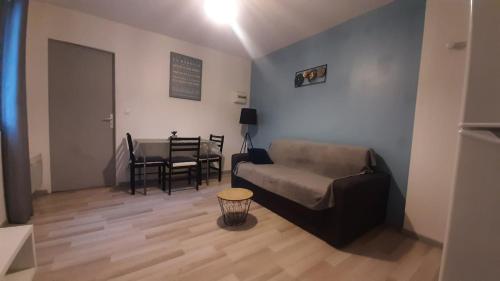 a living room with a couch and a table at 2-bed apartment in Limoges