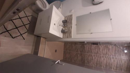 a kitchen with white cabinets and a counter top at 2-bed apartment in Limoges