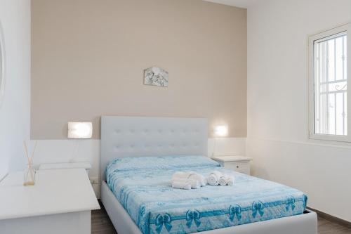 Ένα ή περισσότερα κρεβάτια σε δωμάτιο στο La Perla Di Mare