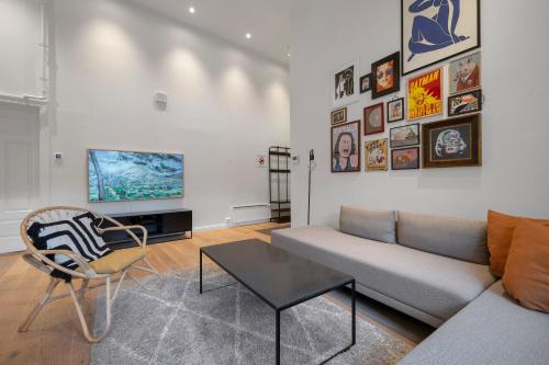 a living room with a couch and a table at Northstay - Town Square in Tromsø
