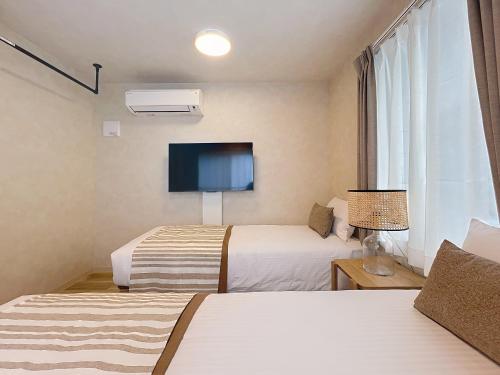 Ένα ή περισσότερα κρεβάτια σε δωμάτιο στο Viento Ikebukuro