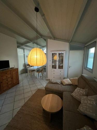 a living room with a couch and a table at Bungalow Het Grootslag in Andijk