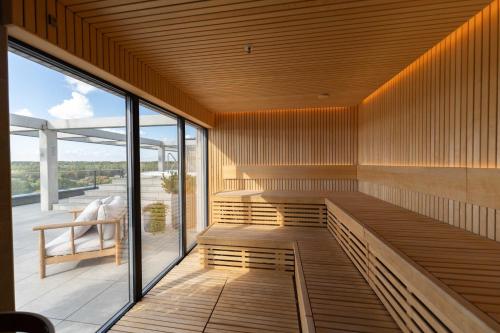 an empty sauna with a bench and a window at Sky Pool Escape Luxury Apartment in Druskininkai Center in Druskininkai