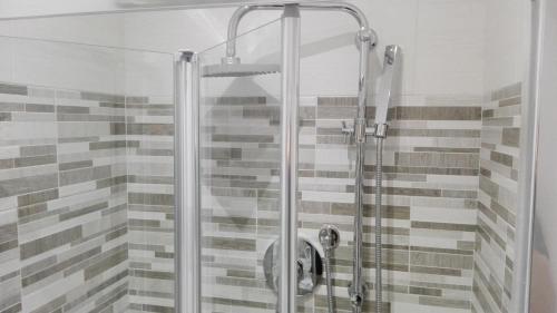 a shower with a glass door in a bathroom at Vatican City Holidays Guesthouse in Rome