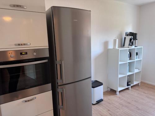 a kitchen with a stainless steel refrigerator in a room at Unger's Ferienwohnung in Isny im Allgäu