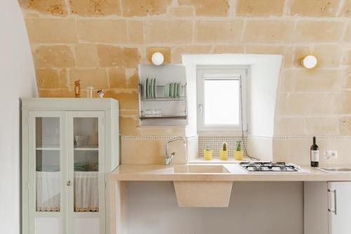 uma cozinha com um lavatório e uma bancada em La Casa di Gianni em Matera