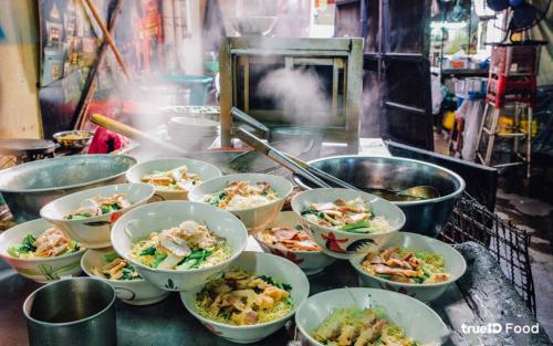 a bunch of bowls of food on a counter at xx The Character Yaowarat เดอะ คาแรคเตอร์ เยาวราช ตรอกข้าวสาร in Samphanthawong