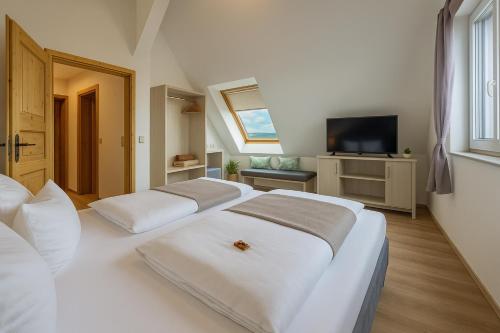 a bedroom with three beds and a television in it at Messehotel Daucher A9 Autobahn 24h Self-Check-in in Nuremberg