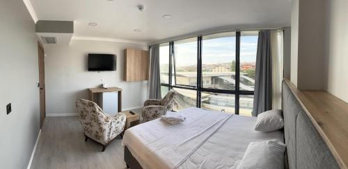 a bedroom with a bed and a large window at The my hotel darica in Darıca