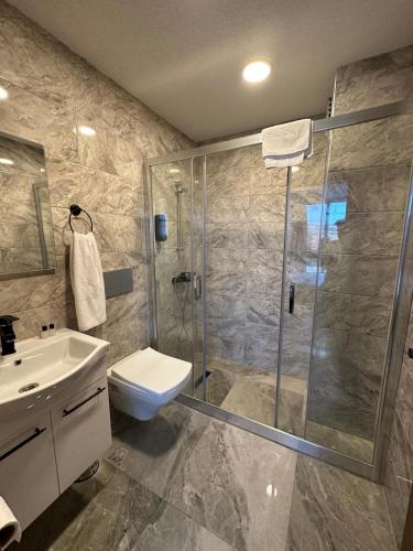 a bathroom with a shower and a toilet and a sink at The my hotel darica in Darıca