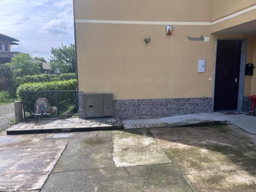 a building with a door and a dog standing outside at Bariola Apartment in Caronno Pertusella