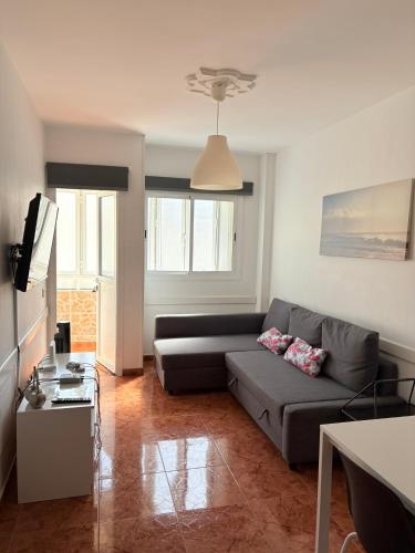 a living room with a couch and a table at Apartamento Allegra in Arinaga