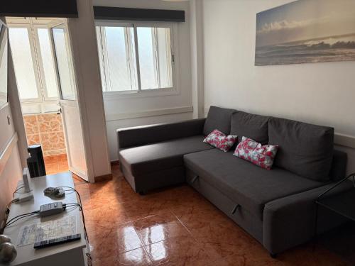 a living room with a couch and a table at Apartamento Allegra in Arinaga