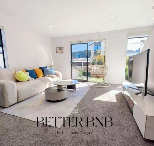 a living room with a couch and a tv at Modern and New 3 Beds fancy home in Upper Hutt
