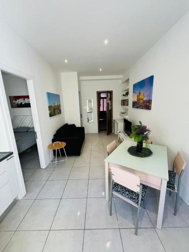 a living room with a table and a couch at Central and Modern Apartment St Julians in St. Julianʼs