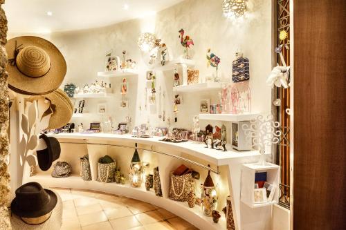a room filled with white shelves filled with vases at Hotel Stella Maris in Villasimius