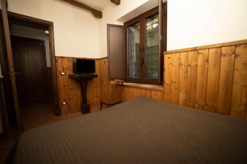 a bedroom with a bed and a window and a door at Parco Statella in Montelaguardia