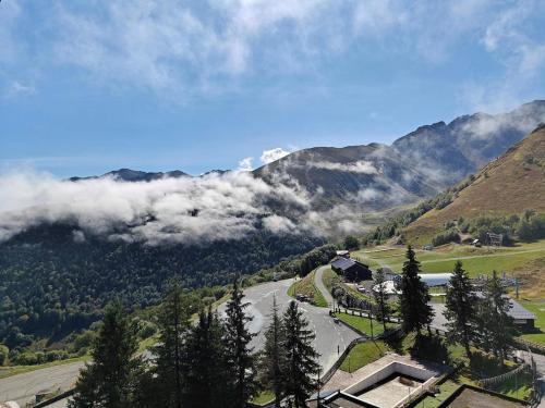 a view of a valley with a road and mountains at Appartement Peyragudes les Agudes in Gouaux-de-Larboust