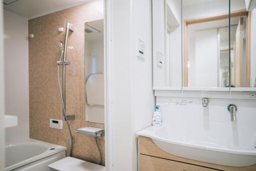 a bathroom with a sink and a shower at Metronest 三軒茶屋 in Tokyo