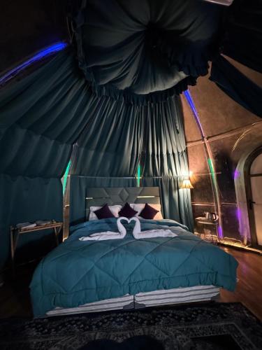 a bedroom with a blue bed with a canopy at Ufo Mussoorie in Mussoorie
