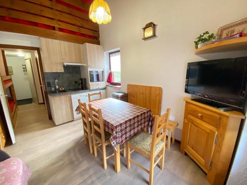 a kitchen and dining room with a table and chairs at Floréa 8 in La Clusaz