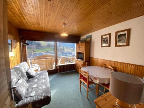 un soggiorno con un divano e un tavolo di Florymar Simon a La Clusaz